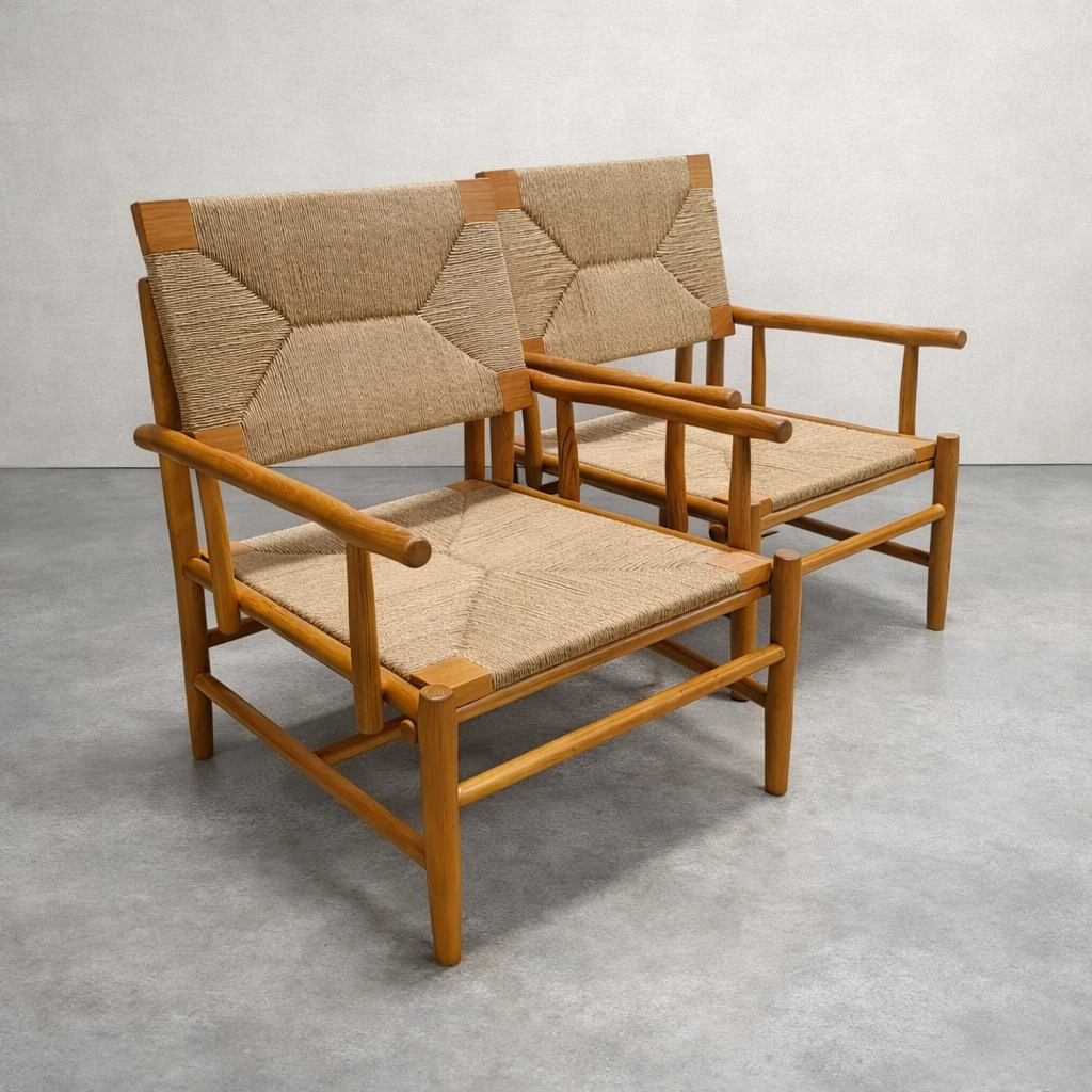Pair of wooden chairs with woven backrests on a gray floor.
